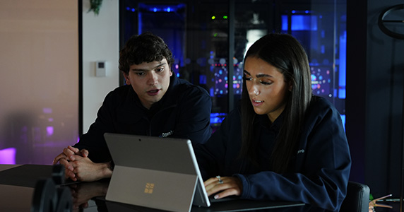 Two operatives discussing work whilst using an electronic tablet